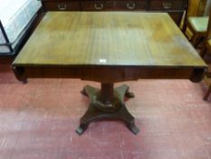 A CIRCA 1900 TWIN FLAP SOFA TABLE on a segmented column with carved detail and quatrefoil base