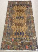 A BALOUCHI RUG, brown and blue ground multi-pattern border with rectangular repeat pattern centre,