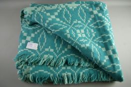 A LARGE WELSH WOOLLEN BLANKET with Trefriw Woollen Mills label, classical patterns in tonal greens