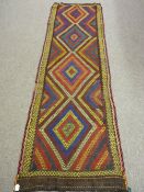 A SUZNI KILIM RUNNER, multi-coloured central diamond pattern with stitched edge border, 233 x 72