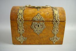 A VICTORIAN WALNUT STATIONERY BOX of dome lidded casket form with gilt pierced brass handle and