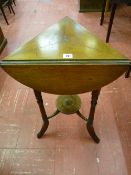 AN EDWARDIAN MAHOGANY TRIPLE FLAP TRIANGULAR SIDE TABLE on three turned and swept supports with