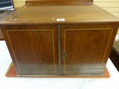 A 19th CENTURY TWO DOOR TABLE CABINET with boxwood string inlay and interior shelf, 33.25 cms