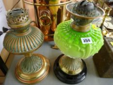 Victorian oil lamp with green glass font and a similarly styled brass example