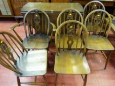 Ercol gate leg dining table and a set of six (four plus two) spindle and splat hoop back dining