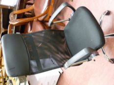 Black upholstered and chrome office swivel armchair with breathable cloth back