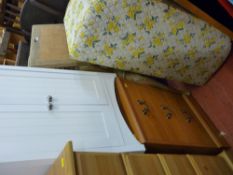 White underbasin storage cabinet, a light wood three drawer melamine chest and a mid Century blanket