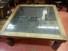 Modern hardwood coffee table with antique style carved top and glass cover