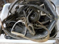 Large plastic crate of horse harnessing/tack leather strapping and stirrups etc