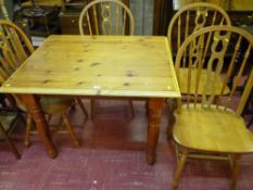 Modern pine dining table and four substantial spindleback chairs