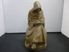 Carved soapstone figure of a seated friar reading a book