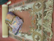 Colourful throw and a washed woollen Chinese rug