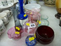 Collection of colourful glassware including a cranberry Mary Gregory style decorated jug