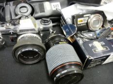 Boxed Lumix digital camera with charger, a Pentax Zoom 90 in case, an Olympus OM10 SLR camera plus