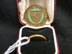 Twenty two carat gold narrow wedding band and an Urdd brooch