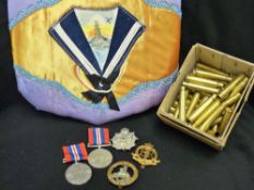 Two unmarked 1939-1945 war medals, three cap badges, quantity of clean spent bullet casings 1940's