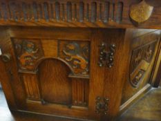 Oak buffet sideboard with excellent carvings to the front including a pair of lions, shields etc