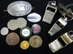 Three vintage metal whistles and a small collection of railway badges and collectable coinage