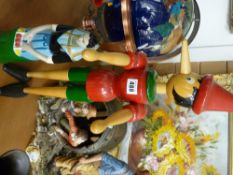 Painted wooden model of Pinocchio and a vintage liqueur bottle in the form of a fruit carrying