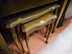 Nest of three leather and glass topped coffee tables