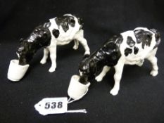 Shebeg I.O.M. - two pottery models of calves drinking from pails, both signed Mooney