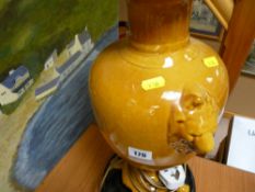 Lion handled and footed pottery table lamp with shade on a pedestal