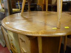 Circular topped light Ercol coffee table and spindlebacked chair