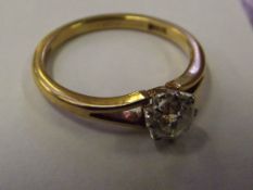 An 18 ct gold solitaire ring with .60 carat diamon