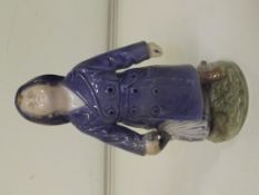Royal Copenhagen figure, modelled as a boy in rain