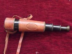 Brass telescope in brown leather case