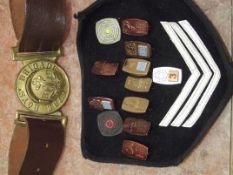 The boys brigade belt together with pin badges