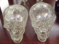 Pair of crinkle glass skulls