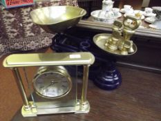 Set of balance scales together with a mantel clock