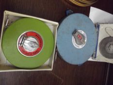 Two vintage tape measures