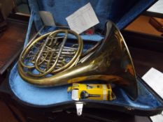 Cased brass French horn