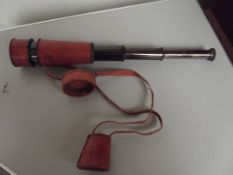 Brass telescope in red leather case