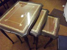 Nest of three glass topped and inset leather table