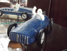 Cast iron Michelin man in racing car