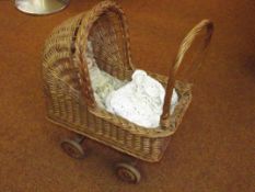 Wicker dolls pram with bisque doll