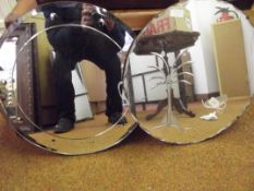 Two circular frameless wall mirrors