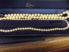 Two pearl necklaces, one having silver clasp