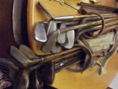 Two bags of early golf clubs, some with hickory sh