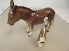 Beswick donkey together with a Szeiler dog