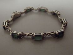 18 ct white gold bracelet with green stones