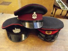 Three military peak hats