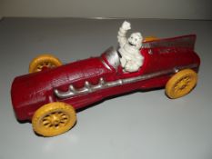Cast iron Michelin man in racing car