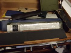 Briefcase containing vintage slide rules and relat