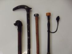 Three various walking canes (one with hounds head