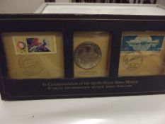 Sterling silver proof coin with two stamps in comm