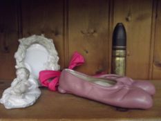 Nao figure, trench art case, ballet shoes and phot